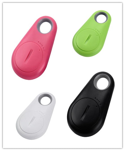 Pink, green, white, and black plastic waterproof Bluetooth tracker for keys and bags with a circular keyring design.