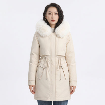 Woman wearing a cream puffer coat with a white faux fur collar and adjustable drawstring waist.