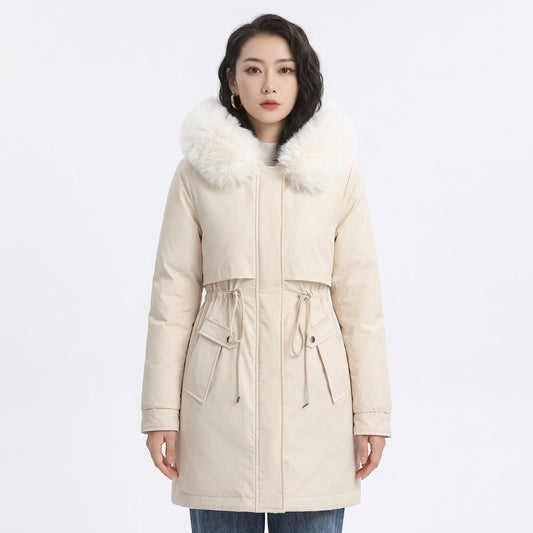 Woman wearing a cream puffer coat with a white faux fur collar and adjustable drawstring waist.