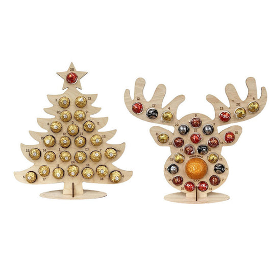 Two wooden advent calendars shaped like a Christmas tree and a reindeer, holding round wrapped candies.