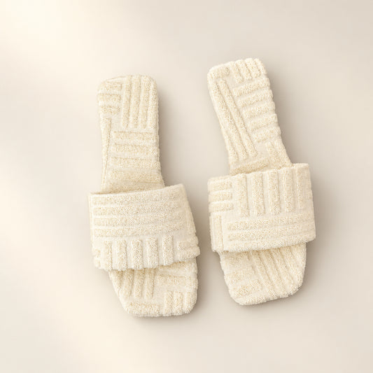 Beige square toe flat slide sandals with textured terry cloth pattern