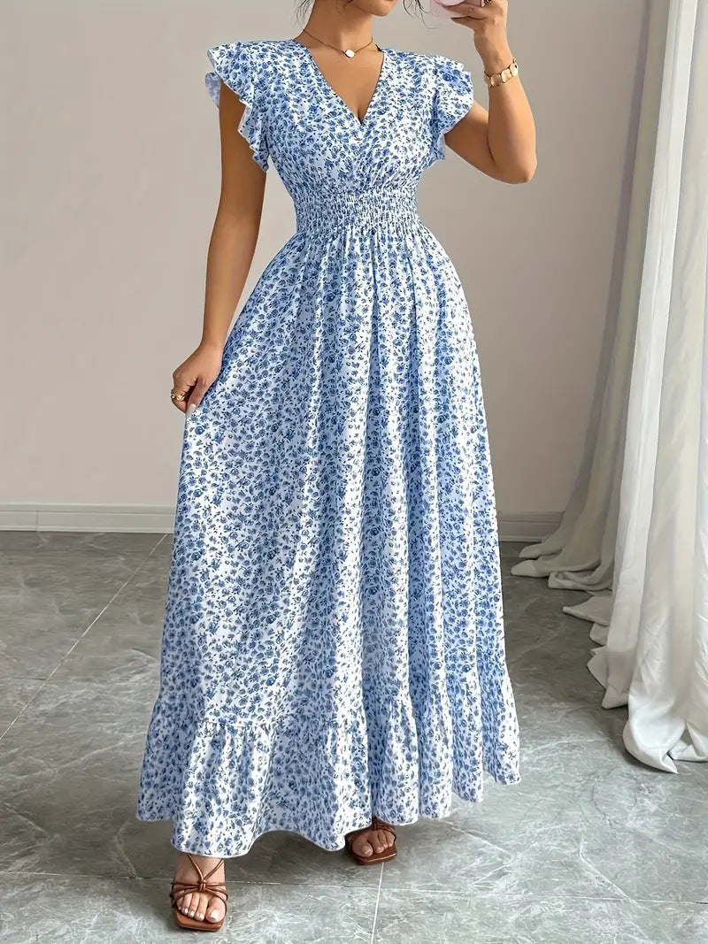 Blue and white floral polyester flowy dress with flutter sleeves for resortwear.