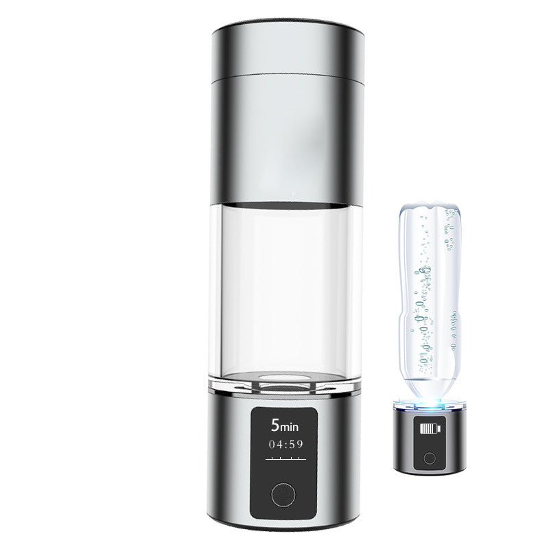 Silver hydrogen water bottle with digital timer display and an adapter base holding a bottled water container.