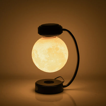 Levitating moon lamp glowing in a dark room, close-up