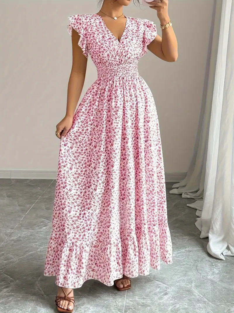 Pink floral flowy polyester dress with a V-neck, ruffle sleeves, and smocked waist for casual resortwear.