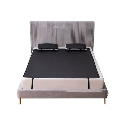 Grounding earthing bed mat spread across a mattress and held by securing straps