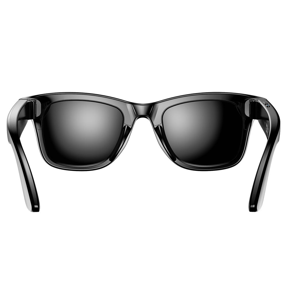 Black, glossy, rectangular smart wearable glasses with an integrated camera for translation during travel and daily use.