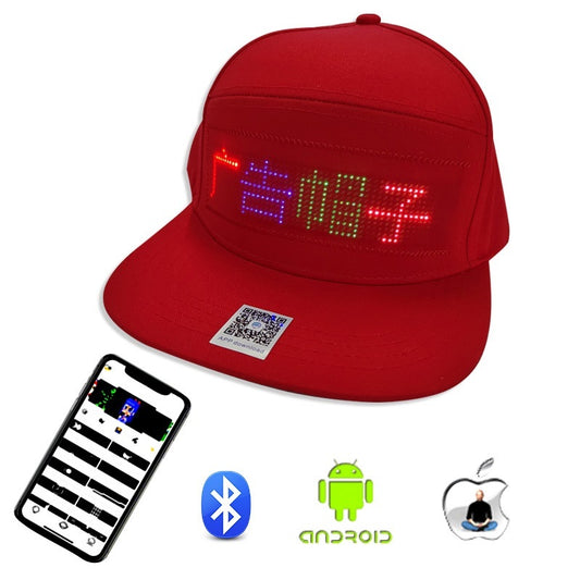Red baseball cap with a programmable LED matrix display showing colored text, paired with a smartphone app interface.