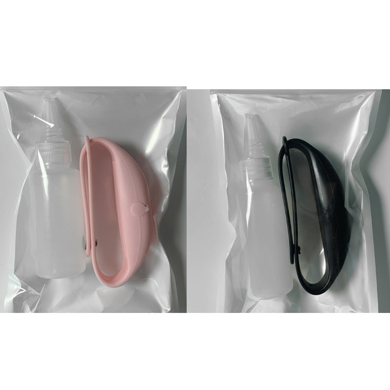 Two packaged silicone dispenser bracelets with refill bottles in pink and black.
