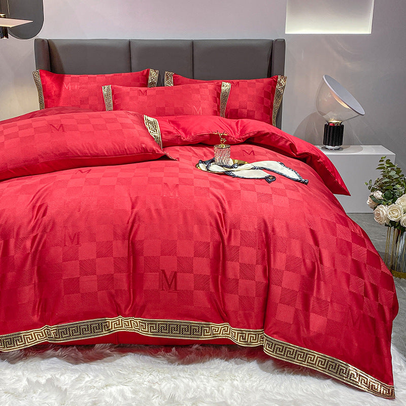 Red checkered bed sheet set with a quilt cover, matching pillows, and a gold geometric key trim.