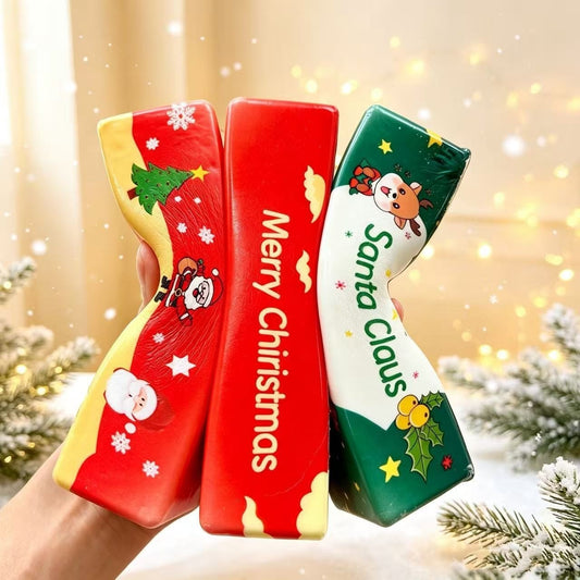 Three Christmas-themed squishy toy butter sticks with festive graphics held in hand.