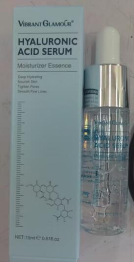 Light blue facial serum box beside a clear glass dropper bottle.