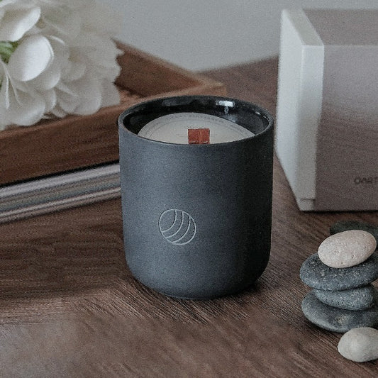 Home decor soy wax candle in ceramic jar with wooden wick and stacked stones