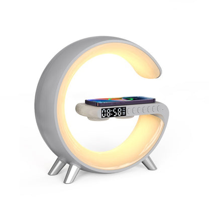 White G-shaped LED lamp with wireless charger, digital clock, and Bluetooth speaker for bedside desk use.