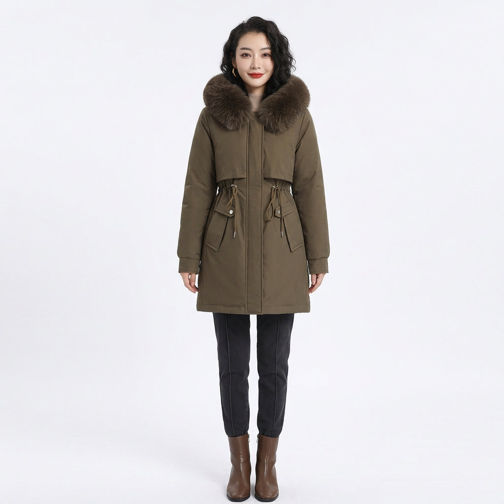 Woman wearing an olive green puffer coat with a fluffy fur-trimmed hood and drawstring waist.
