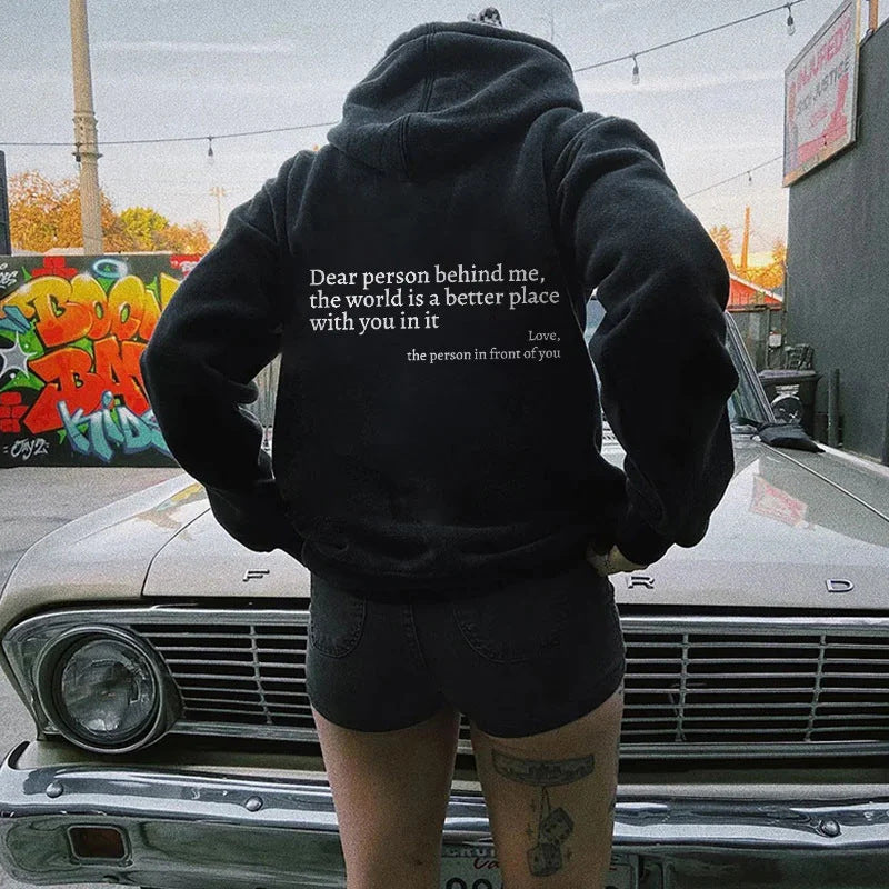 Black oversized hoodie with white text on back for daily wear.