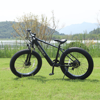 Matte black aluminum frame electric bike with fat tires for off-road trail riding.