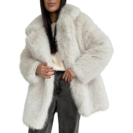 A person wearing a fluffy white faux-fur coat with a wide lapel collar over dark jeans.