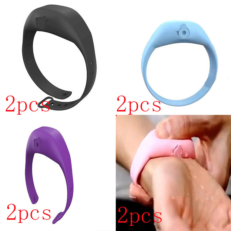 Close-up of a hand squeezing a pink silicone bracelet dispenser worn on a wrist.