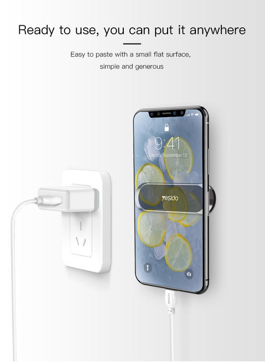 Magnetic phone car mount mounted on a wall next to a wall charger