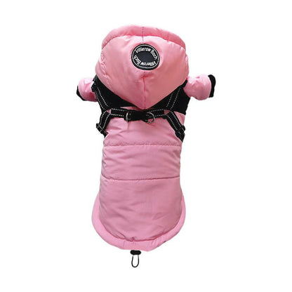 Pink quilted dog coat with a built-in black harness and hood, viewed from the back