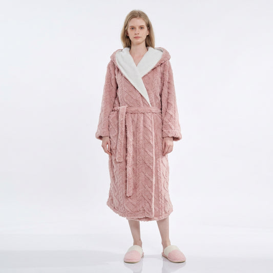 Woman wearing a pink textured plush hooded bathrobe with a matching tie belt and white contrast shawl collar.