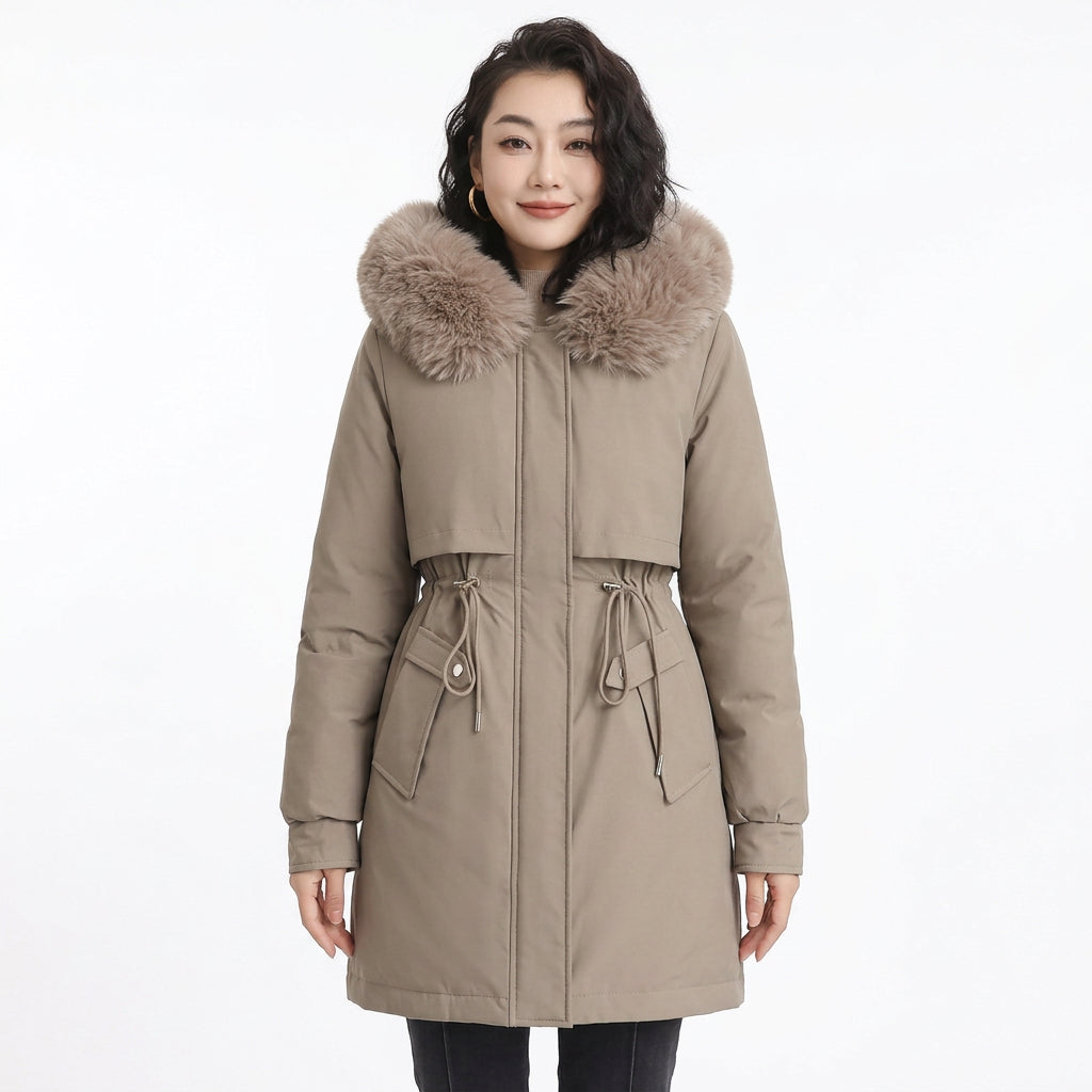 Woman wearing a tan puffer coat with a plush faux fur hood and drawstring waist.