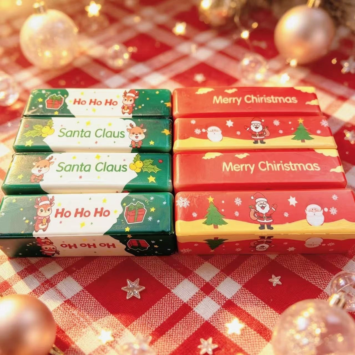 Christmas themed squishy toys arranged on a red and white plaid tablecloth.