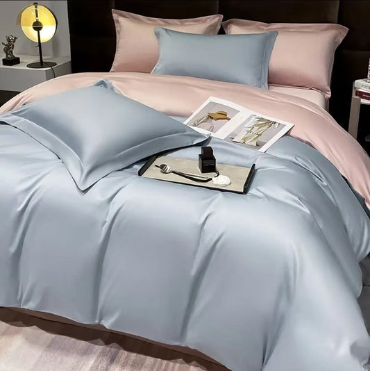 Bed made with pink and light blue silky duvet cover, matching pillowcases, and an open magazine.