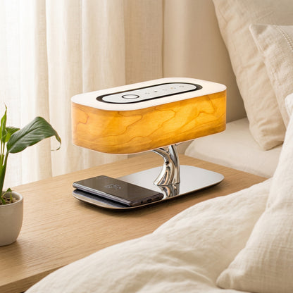 Wood-grain bedside table lamp with tree-branch base and wireless charging pad holding a smartphone