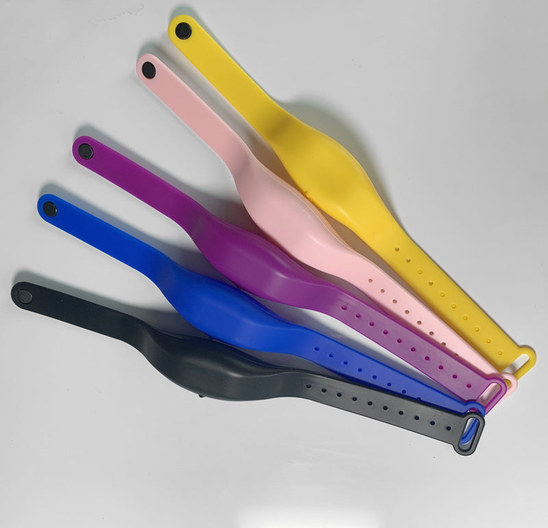 Five silicone refillable wristbands in yellow, pink, purple, blue, and black displayed flat.