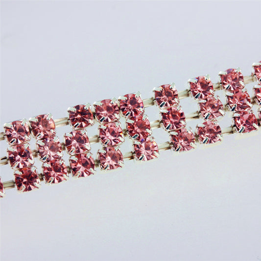 Close-up of a three-row pink rhinestone pet collar with silver-tone metal settings.