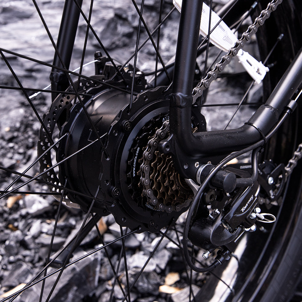 Black aluminum hub motor on an electric mountain bike for off-road trail riding.