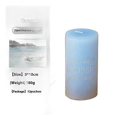 Home decor scented blue cylindrical wax pillar candle on a wooden tray with an ocean