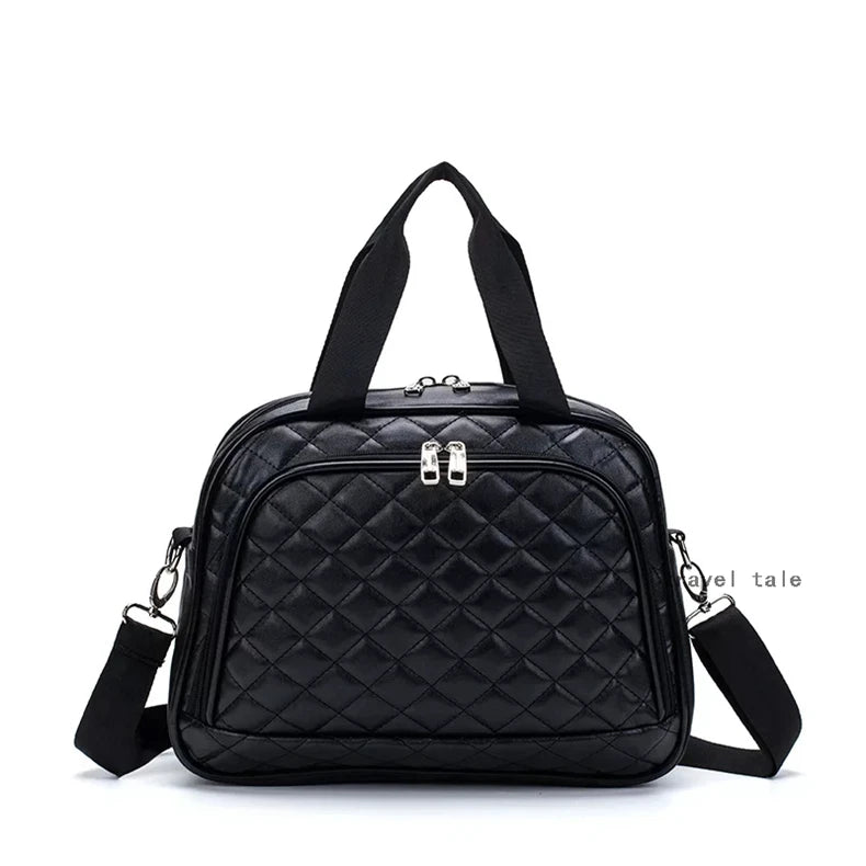 Black quilted leather travel duffel bag with dual top handles, front zip pocket, and detachable shoulder strap.