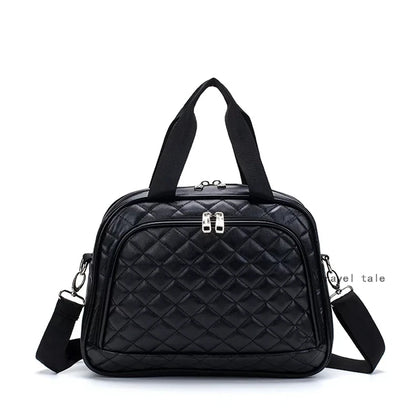 Black quilted leather travel duffel bag with dual top handles, front zip pocket, and detachable shoulder strap.