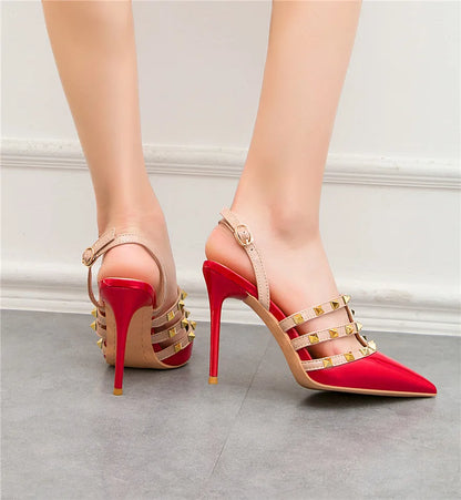 Red patent pumps with gold stud straps and ankle buckles for office dress shoes.
