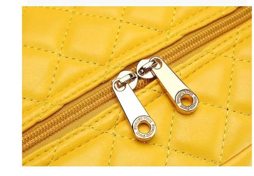 Yellow quilted PU luggage with gold zipper pulls and dual zippers.