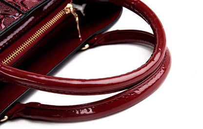 Dark red faux leather structured tote with zip closure and polished finish for everyday use.