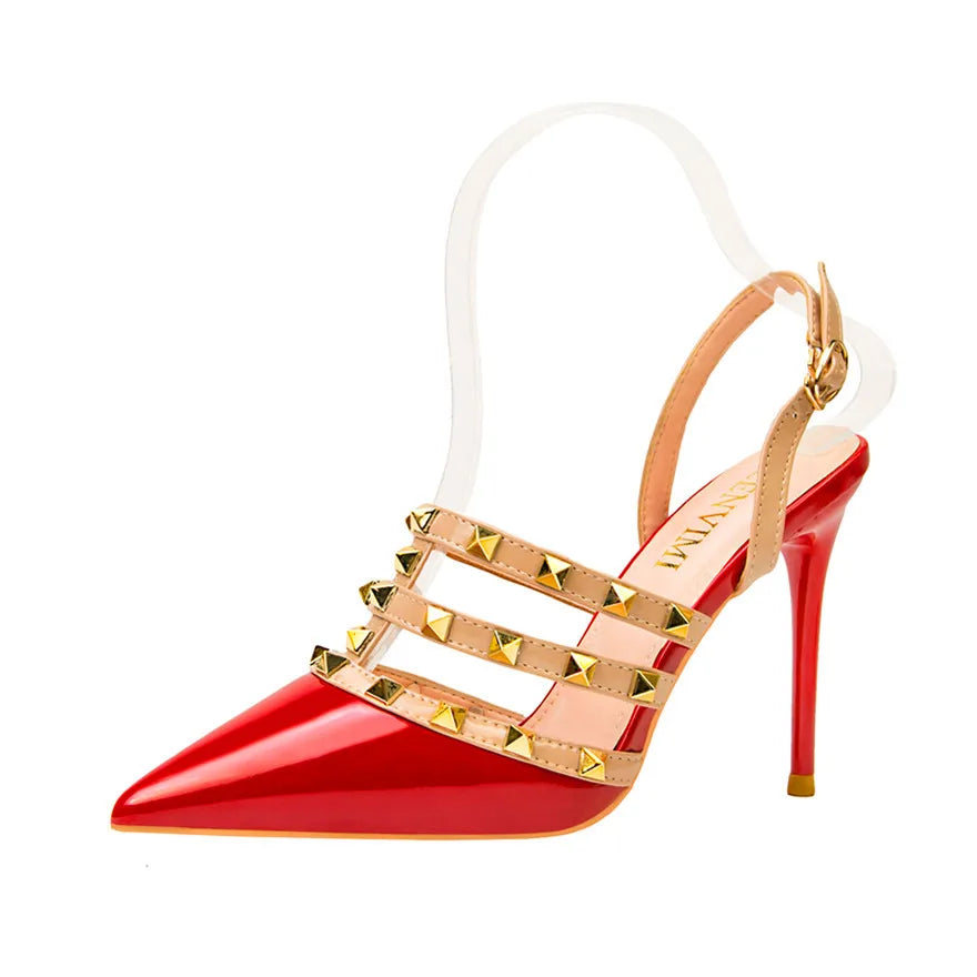 Red patent leather pointed-toe heels with beige strappy rivet details, cushioned insole, and ankle buckle for the office.