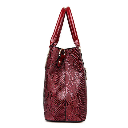 Dark red faux leather tote with snake-pattern texture and zip closure for daily essentials.