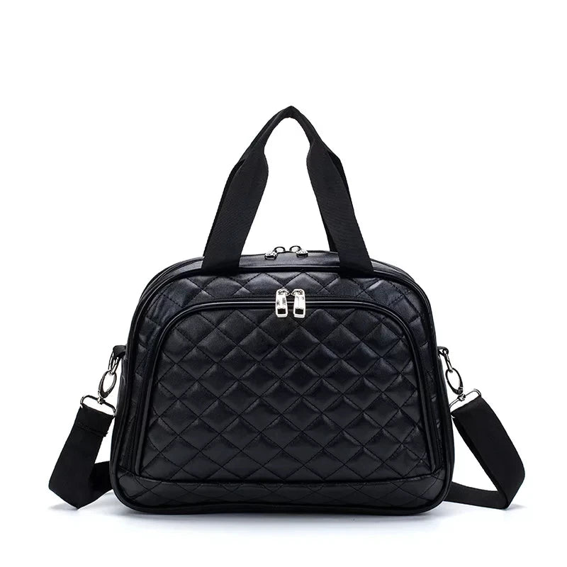 Black quilted leather travel bag with top handles, front zip pocket, and detachable shoulder strap.