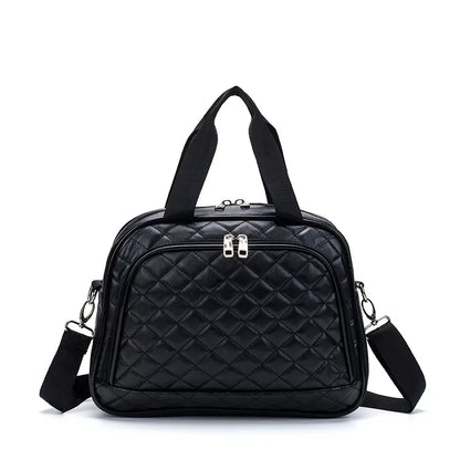 Black quilted leather travel bag with top handles, front zip pocket, and detachable shoulder strap.