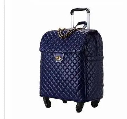 Dark blue quilted PU leather rolling luggage with a chain detail, lock clasp, and retractable handle.
