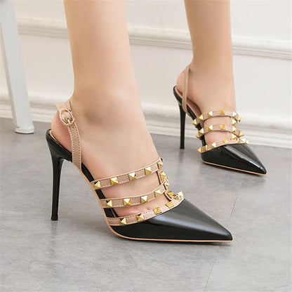 Black patent pumps with studded beige straps and adjustable ankle closure, a non-slip office dress shoe.