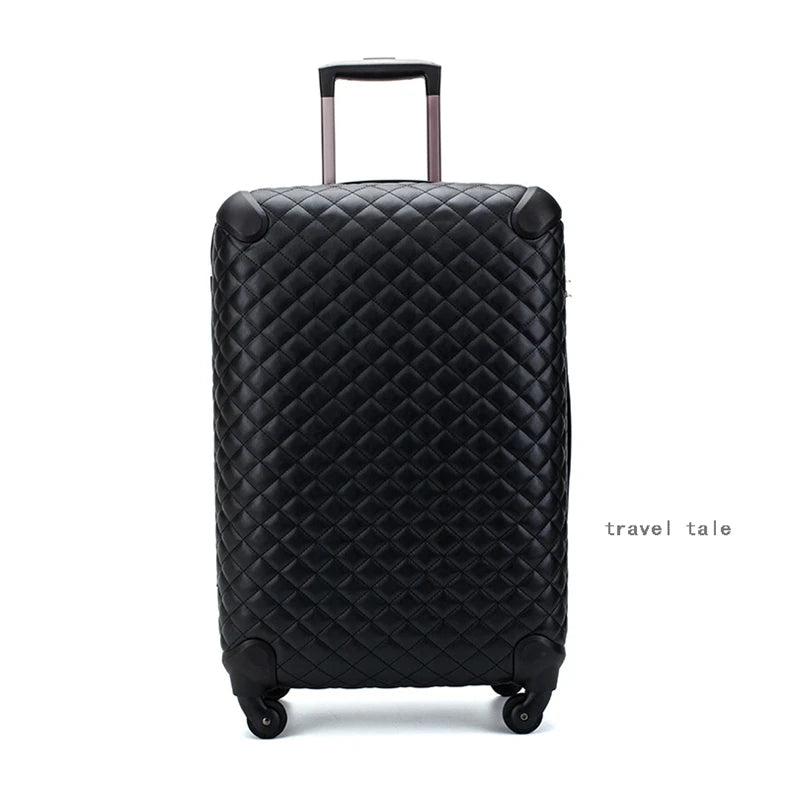 Black quilted leather spinner suitcase with a retractable handle and reinforced corner guards.