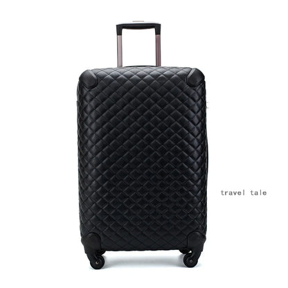 Black quilted leather spinner suitcase with a retractable handle and reinforced corner guards.