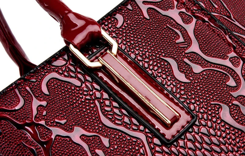 Deep red faux leather shoulder tote with gold hardware and embossed texture for daily use.