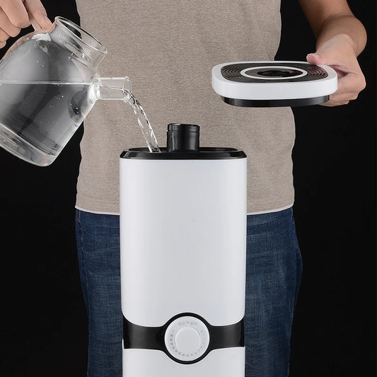 Home decor essential oil diffuser ultrasonic mist humidifier large tank being filled with water from glass pitcher
