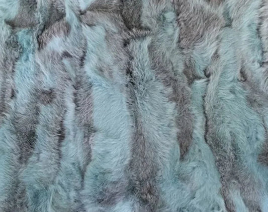 Close-up of soft blue and gray patchwork fur texture.